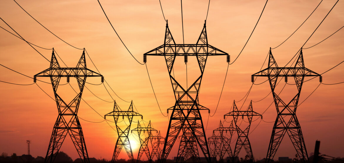 Electricity Pylons at sunset on background